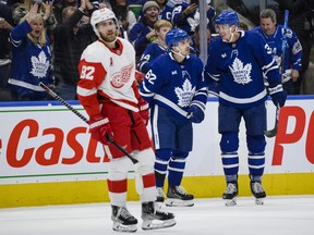 Toronto Maple Leafs centre Denis Malgin (62) celebrates his goal with defenceman Justin Holl as Detroit Red Wings defenceman Jordan Oesterle looks on during the second period on Saturday at Scotiabank Arena.