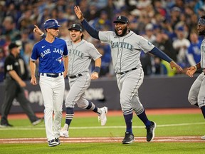 Mariners relief pitcher Diego Castillo (63) celebrates Seattle's victory over the Toronto Blue Jays in Game 2 of their wild-card series on Saturday at the Rogers Centre. The Mariners advances to face Houston.