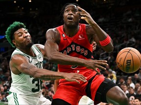 Boston Celtics guard Marcus Smart (left) blocks a shot Raptors’ OG Anunoby in Boston last night.