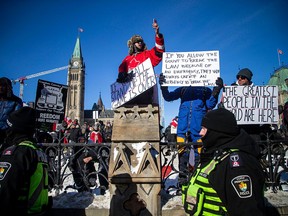 Supporters of the truckers' Freedom Convoy gather around Parliament Hill on Sunday Jan. 30, 2022.