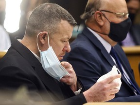Paul Flores puts on a new N95 mask Aug. 3, 2021, at a preliminary hearing in San Luis Obispo, Calif.