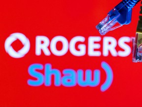 Ethernet cables are seen in front of Rogers and Shaw Communications logos in this illustration taken, July 8, 2022.