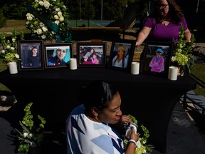 People set up a memorial table with images of the victims of a shooting in the Hedignham neighborhood on October 15, 2022 in Raleigh, North Carolina.