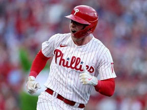 Rhys Hoskins of the Phillies celebrates after hitting a three-run home run against the Braves during the third inning in Game 3 of the National League Division Series at Citizens Bank Park in Philadelphia, Oct. 14, 2022.
