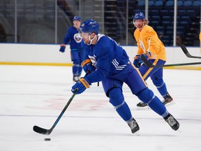 Riley Sheahan of the Buffalo Sabres skates with the puck as Eric Staal looks on during training camp at KeyBank Center on Jan. 1, 2021 in Buffalo, N.Y.