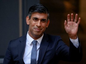 New leader of Britain's Conservative Party Rishi Sunak waves outside the party's headquarters in London, Monday, Oct. 24, 2022.