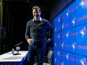 Toronto Blue Jays general manager walks off the stage after talking to the media on Tuesday.