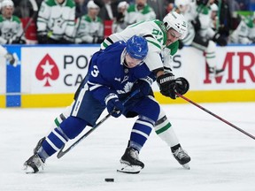 Dallas Stars forward Mason Marchment battles with Toronto Maple Leafs defenceman Justin Holl during the second period at Scotiabank Arena on Oct. 20, 2022.