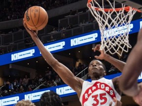 Christian Koloko of the Toronto Raptors takes the ball to the basket during an NBA preseason game against the Utah Jazz at Rogers Place . Edmonton on Oct. 2, 2022.