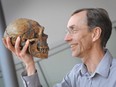 Swedish geneticist Svante Paabo, director of Leipzig's Max Planck Institute for Evolutionary Anthropology holds a skull in this handout picture taken in Leipzig, Germany, April 27, 2010.