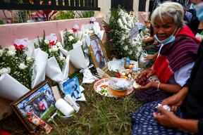 Victims’ families gather during a religious ceremony to call back victims’ souls outside the daycare centre, which was the scene of a mass shooting in the town of Uthai Sawan, in the province of Nong Bua Lam Phu, Thailand, Oct. 9, 2022.