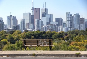 A park bench with graffiti overlooking the downtown skyline along Broadview Ave. in Toronto, Ont. on Wednesday, Oct, 5, 2022.