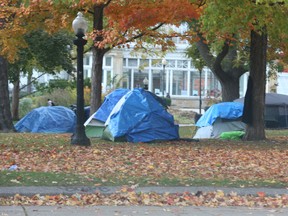 At least 35 tents, and the homeless, now fill sections of Allan Gardens and behind the conservatory. Four tents are located behind the conservatory right beside a children's fenced in playground on Wednesday October 19, 2022. Jack Boland/Toronto Sun/Postmedia Network