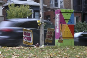 Signage, flowers, speed cams are all visible on Parkside Dr. on Thursday, Oct. 20, 2022, one year after Valdemar and Fatima Avila were killed in a horrific crash, yet motorists continue to ignore the posted 40 km/h speed limit.