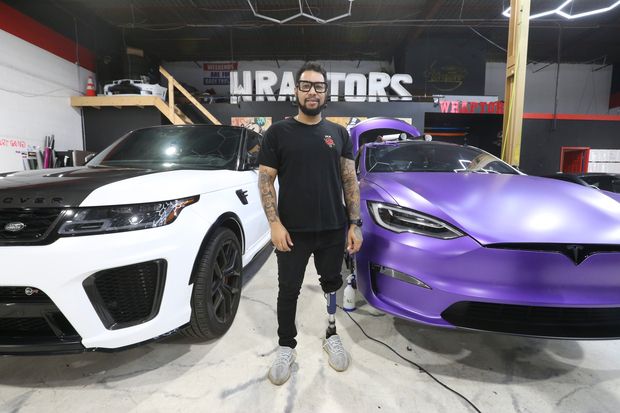 Donny Kashh was shot six times and beaten outside a bar near the  the airport. He was put into a coma for five days and woke up to find he was missing the bottom of his left leg. He fell into a depression and has now found his passion in mental health advocacy. He is pictured at his workplace, Wraptors Inc., a high-end car wrapping business, in Mississauga on Wednesday, Oct. 26, 2022. 