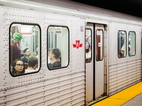 A women looks out from the window of a packed subway car on the Bloor-Danforth line in Toronto.