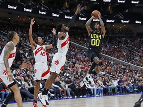 Utah Jazz guard Jordan Clarkson takes a shot over Raptors forward Josh Jackson (12) and forward Dalano Banton (45) during the fourth quarter at Rogers Place in Edmonton on Sunday night.