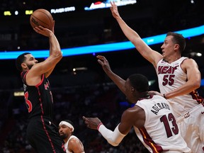 Toronto Raptors guard Fred VanVleet (23) shoots the ball over center Bam Adebayo (13) and Miami Heat guard Duncan Robinson (55) during the first half at FTX Arena on Monday night.