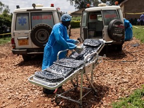 Red Cross workers clean ambulances prior to transporting Ebola victims to a hospital in Mubende, Uganda, Oct. 13, 2022.
