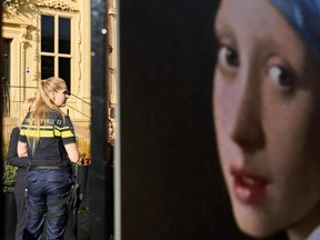A police officer stands guard outside the Mauritshuis museum after an attempt to smear the Johannes Vermeer's painting "Girl with a Pearl Earring" in The Hague, Oct. 27, 2022.