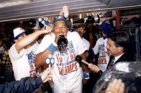 Dave Winfield guzzles some champagne in the middle of a chaotic Jays clubhouse after Toronto won the World Series. But this would be the only year Winfield played in a Jays uniform. STAN BEHAL/SUN FILES