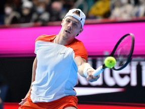 Denis Shapovalov of Canada hits a return against Borna Coric of Croatia during their men's singles quarter final match at the Japan Open tennis tournament in Tokyo on October 7, 2022.