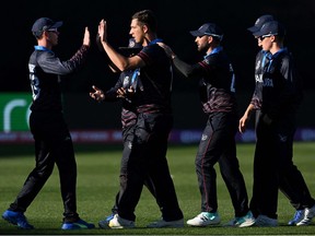 Namibia's JJ Smit (C) celebrates a wicket with teammates during the ICC mens Twenty20 World Cup 2022 cricket match between Namibia and Netherlands at Kardinia Park in Geelong on October 18, 2022.