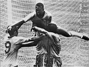 Taken on June 21, 1970 shows Brazilian forward Pele (top) celebrating with his teammates (from L) Tostao, Carlos Alberto and Jairzinho during the World Cup final between Brazil and Italy, in Mexico City. FILE / Getty Images