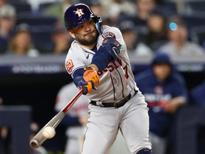 Jose Altuve of the Houston Astros hits a double against the New York Yankees during Game 3 of the American League Championship Series at Yankee Stadium on October 22, 2022.