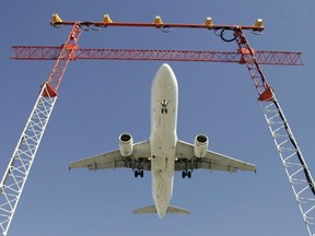 An Air Canada flight makes its final approach as it lands at Pearson International Airport in Toronto, Sept. 30, 2004. The holiday travel season could be affected by delays as the air transport sector's persisting labour shortages will cause unavoidable service disruptions says the president of the Canadian Air Traffic Control Association.