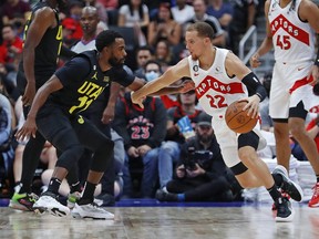 Oct 2, 2022; Edmonton, Alberta, CAN; Toronto Raptors guard Malachi Flynn (22) carries the ball around Utah Jazz guard Mike Conley (11) during the third quarter at Rogers Place.