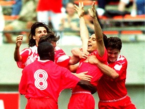 Eddy Berdusco is congratulated by his teammates after scoring a tying goal against Brazil on June 5, 1994. FILE / Postmedia