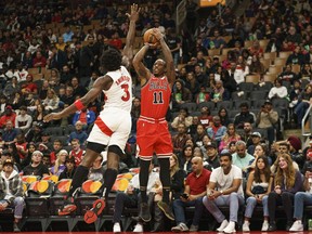 Chicago Bulls guard DeMar DeRozan (11) makes a jump shot over Toronto Raptors forward O.G. Anunoby (3) during the first quarter of an NBA preseason game in Toronto on Sunday, Oct. 9, 2022.