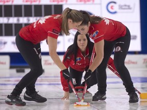 Calgary Ab,October 31,2022. WinSport. Team Canada skip Kerri Einarson delivers her stone to her front end (L) lead Briane Harris and 2nd. Shannon Birchard (R) during draw 1 against team New Zealand.