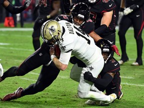 Andy Dalton of the New Orleans Saints carries the ball against the Arizona Cardinals at State Farm Stadium on October 20, 2022 in Glendale, Arizona.