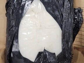 Large package of cocaine inside black garbage bag.