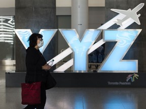 A woman walks through Pearson International Airport in Toronto, March 16, 2020.