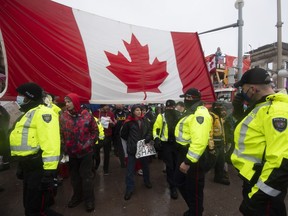 Police attempt to hand out notices on the 21st day of the "Freedom Convoy" protest, in Ottawa, Feb. 17, 2022.