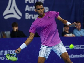 Felix Auger-Aliassime hits a return to Manuel Guinard during their ATP European Open match in Antwerp on October 20, 2022.