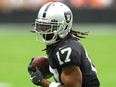 Oct 2, 2022; Paradise, Nevada, USA; Las Vegas Raiders wide receiver Davante Adams (17) gains yardage against the Denver Broncos during a game at Allegiant Stadium.