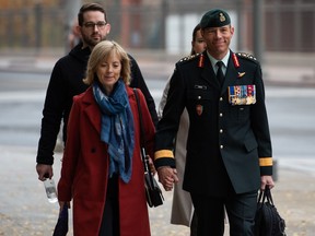 Maj.-Gen. Dany Fortin, right, arrives with his wife Madeleine Collin at a Gatineau, Que. courthouse on Tuesday, Oct. 25, 2022.