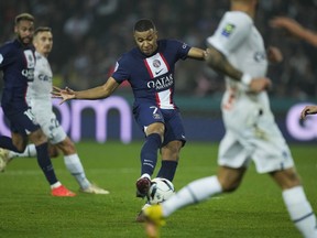PSG's Kylian Mbappe,centre, shots on target during the French League One soccer match between Paris Saint-Germain and Marseille at the Parc des Princes in Paris, Sunday, Oct. 16, 2022.