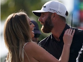 Dustin Johnson embraces his wife Paulina Gretzky after winning the team championship in the season finale of the LIV Golf series at Trump National Doral.