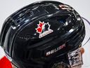 A Hockey Canada logo is seen on the helmet of a national junior team player during a training camp practice in Calgary, Tuesday, Aug. 2, 2022.