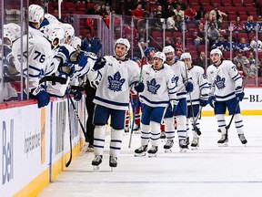 Oct 3, 2022; Montreal, Quebec, CAN; Toronto Maple Leafs center Alexander Kerfoot celebrates his second goal of the game with his teammates at the bench during the third period at Bell Centre.