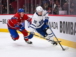 Oct 3, 2022; Montreal, Quebec, CAN; Montreal Canadiens center Christian Dvorak (28) chases Toronto Maple Leafs right wing Mitch Marner (16) along the boards during the first period at Bell Centre.