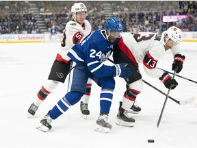 Sep 24, 2022; Toronto, Ontario, CAN; Toronto Maple Leafs right wing Wayne Simmonds (24) battles for the puck with Ottawa Senators right wing Jayce Hawryluk (13) during the third period at Scotiabank Arena.
