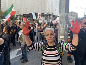 Marges painted her hands red, to symbolize the blood spilled daily by the Iranian regime, as she attended a massive rally in downtown Toronto on Saturday, Oct. 22, 2022.