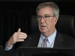 Ottawa Mayor Jim Watson gestures as he responds to a question from counsel during testimony at the Public Order Emergency Commission, Tuesday, Oct.18, 2022 in Ottawa.