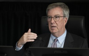 Ottawa Mayor Jim Watson gestures as he responds to a question from counsel during testimony at the Public Order Emergency Commission, Tuesday, Oct.18, 2022 in Ottawa.